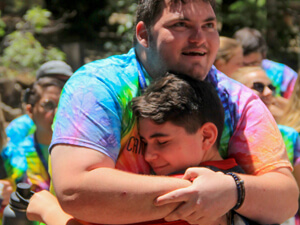 Staff and camper hugging